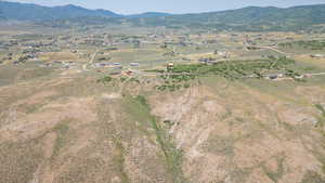 Aerial view of property's location featuring a mountain backdrop and rural landscape