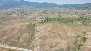Aerial view of property's location with a mountainous background and rural landscape