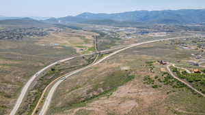 Aerial overview of property's location featuring a mountain backdrop and rural landscape