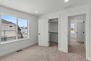 Unfurnished bedroom with carpet floors, a spacious closet, recessed lighting, and a closet