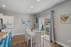 Dining room with recessed lighting and wood finished floors