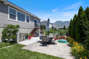 View of patio / terrace with stairway, a mountain view, and area for grilling