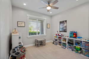 Rec room with ceiling fan, carpet, and recessed lighting