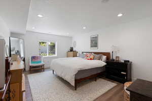 Bedroom featuring wood finished floors, recessed lighting, and a textured ceiling
