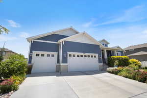 Single story home featuring a garage and concrete driveway