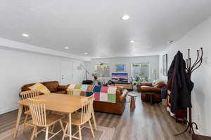 Dining room featuring wood finished floors, recessed lighting, and a textured ceiling