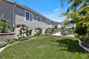 View of green lawn featuring a patio and a residential view