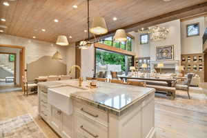 Kitchen with open floor plan, wood ceiling, recessed lighting, light wood-style floors, and a chandelier