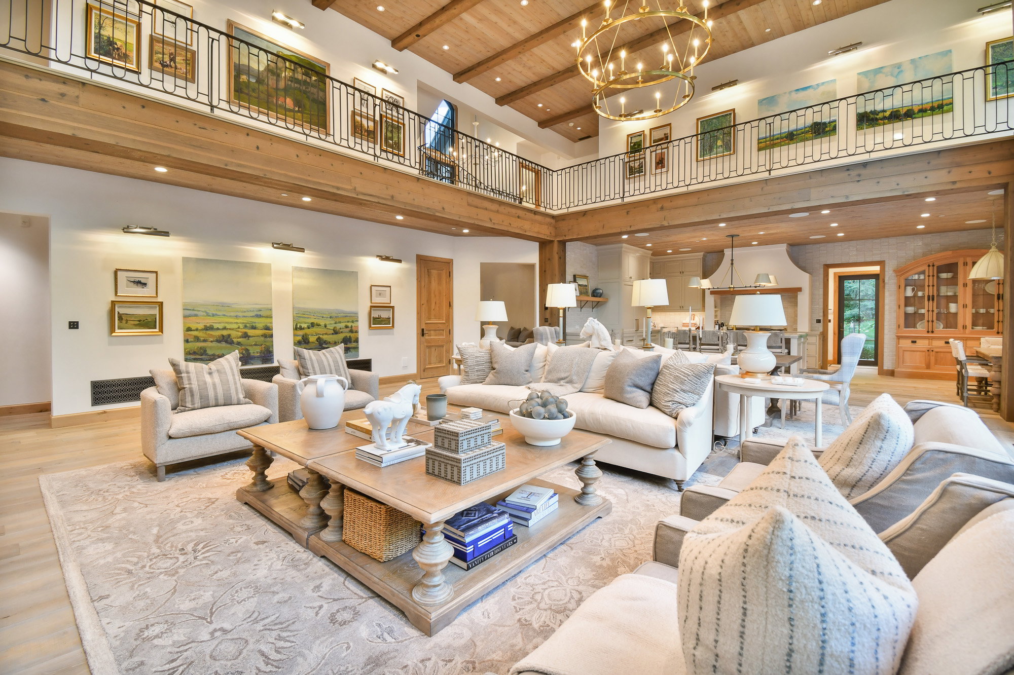Living room featuring a wood ceiling with exposed beams, a high ceiling, wood finished floors, a chandelier, and recessed lighting