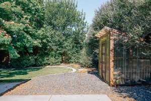 View of grassy yard featuring an outdoor structure