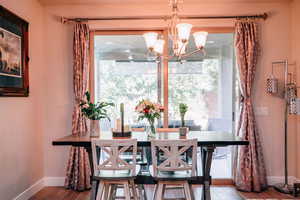 Dining area featuring wood finished floors and a chandelier