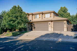 Prairie-style house with stucco siding, concrete driveway, stone siding, an attached garage, and a tile roof
