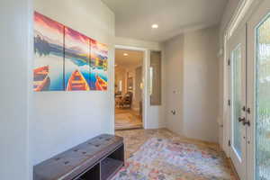 Entrance foyer with french doors and recessed lighting
