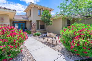 Entrance to property with stucco siding, a tiled roof, and french doors