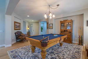 Rec room featuring light wood-style flooring, arched walkways, recessed lighting, and pool table