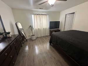 Bedroom with wood finished floors and a ceiling fan
