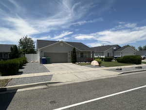 Ranch-style house featuring a garage and driveway