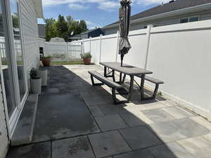 Fenced backyard with outdoor dining space and a patio area