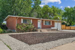Ranch-style home with brick siding, an attached garage, and driveway