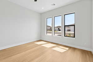 Empty room with light wood-style flooring, ceiling fan, and recessed lighting
