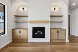 Unfurnished living room with light wood-style flooring and a fireplace