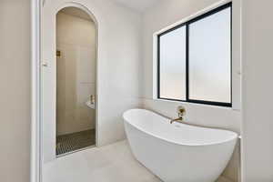 Full bath featuring a freestanding bath and a stall shower
