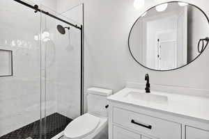 Full bathroom featuring vanity and a shower stall