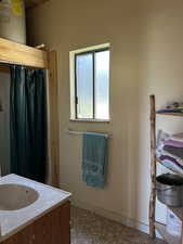 Bathroom with vanity, a shower with shower curtain, tile patterned floors, and electric water heater