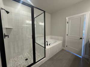 Full bath featuring tile patterned flooring, a shower stall, and a bath