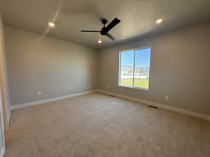 Unfurnished room featuring a ceiling fan, light carpet, and recessed lighting