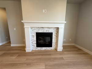 Detailed view of a stone fireplace and wood finished floors