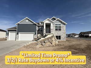 Craftsman inspired home featuring stone siding, board and batten siding, driveway, and an attached garage
