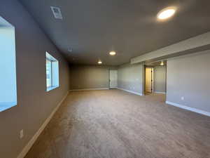 Spare room featuring recessed lighting and light carpet