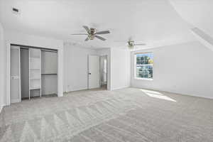 Unfurnished bedroom featuring carpet flooring and ceiling fan