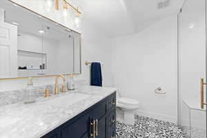 Full bathroom featuring vanity, tile patterned floors, and a shower