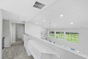 Hallway with carpet flooring, recessed lighting, arched walkways, and lofted ceiling