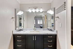 Bathroom featuring vanity and ornamental molding