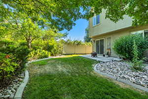 Fenced yard featuring a patio