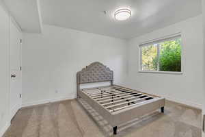 Unfurnished bedroom with carpet flooring and baseboards