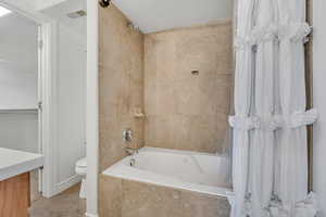 Full bath with tiled shower / bath, tile patterned flooring, and vanity