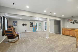 Living area featuring recessed lighting and light colored carpet