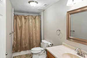 Bathroom with vanity and a textured ceiling