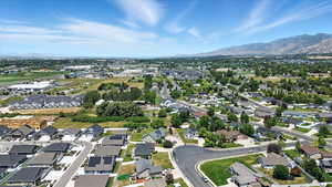 Aerial view of property's location with nearby suburban area and a mountain backdrop