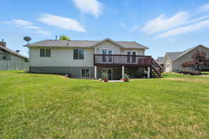 Rear view of house with a wooden deck and stairway