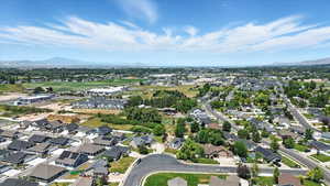 View of property location featuring mountains and nearby suburban area