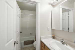 Bathroom featuring vanity,  shower combination, and tile patterned floors