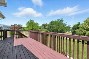Wooden terrace featuring a yard