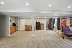 Finished basement featuring light carpet and recessed lighting