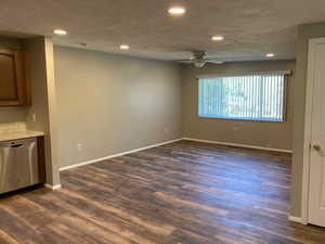 Unfurnished room with a ceiling fan, dark wood-type flooring, and recessed lighting