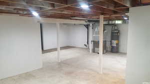 Unfinished basement with water heater and heating unit